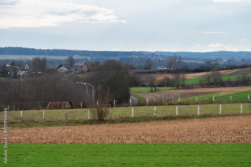 Obraz premium Green meadows and fields at the hills of the Flemish countryside around Leuven, Brabant, Belgium