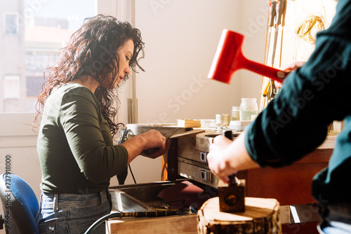 Professional jewelers working in workshop together