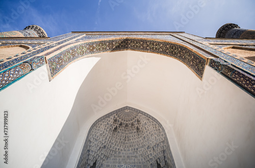 Facade of the Gur Emir mausoleum with mosaic brick walls in the ancient city of Samarkand in Uzbekistan, oriental architecture photo