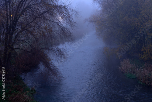 Arlanzon river in the mist in the city of Burgos. Castilla y Leon, Spain.