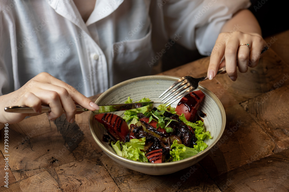 Woman eating salad in a restaurant, close-up. Healthy food. chicken liver salad Woman eating salad in a restaurant, close-up. Healthy food. chicken liver salad