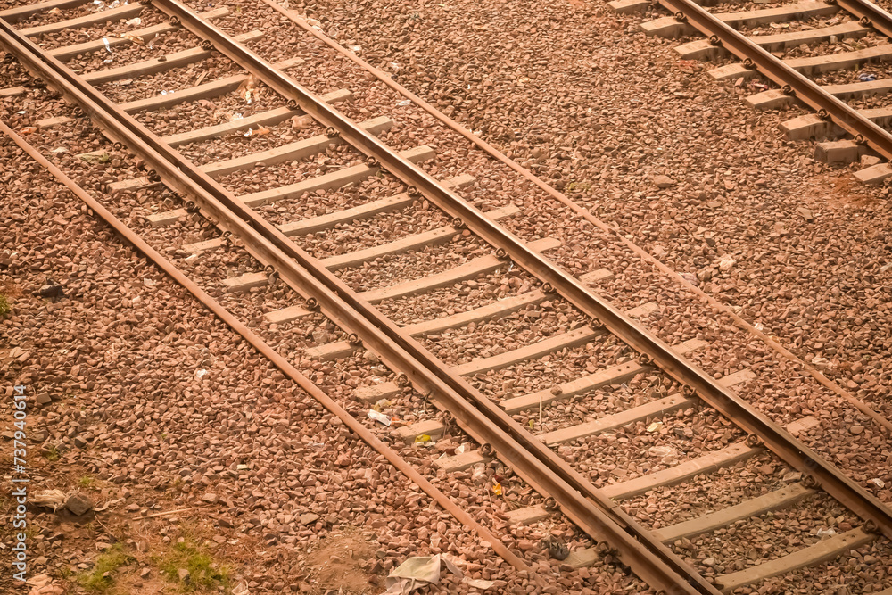 View of train Railway Tracks from the middle during daytime at Kathgodam railway station in India, Train railway track view, Indian Railway junction, Heavy industry View of train Railway Tracks from the middle during daytime at Kathgodam railway station in India, Train railway track view, Indian Railway junction, Heavy industry