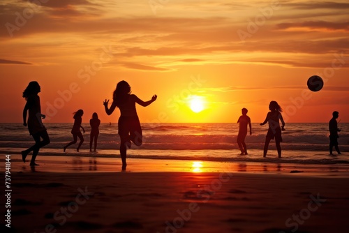 silhouettes of people playing with ball on the beach in water at sunset in summer. Tourists living healthy lifestyle, having fun.