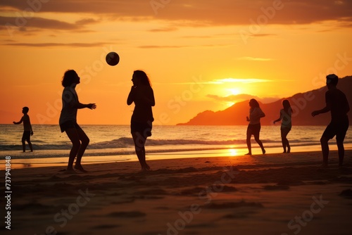 silhouettes of people playing with ball on the beach in water at sunset in summer. Tourists living healthy lifestyle, having fun.