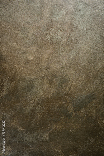 Brown textured surface with golden hue. Stone imitation. Top view.