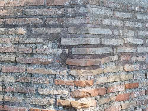 Old stone wall, exterior facade of a house. Full frame