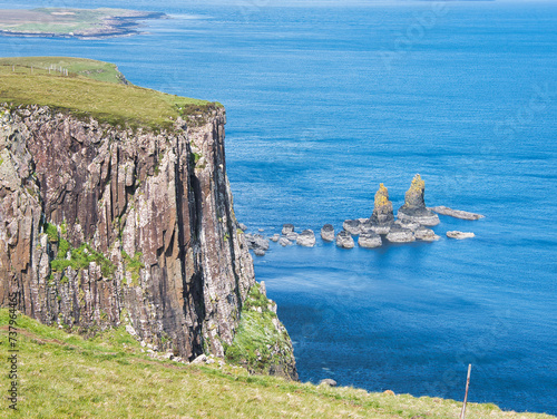 Kilt Rock on the Isle of Skye (Scotland) - cliffs with a columnar structure and small rocky islands in the sea. 