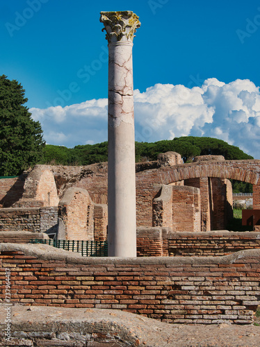 Ostia Antica archaeological site with marble column and ruins. Ostia Antica was an ancient Roman city