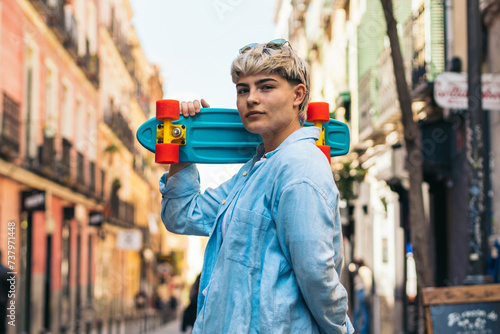 stylish teenager girl with short hair and a skate. portrait