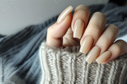 Female hand with beige nail design, Nail Polish. Art Manicure. Modern style pink Nail Design.