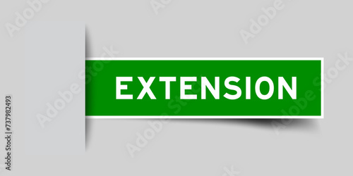 Green color square label sticker with word extension that inserted in gray background