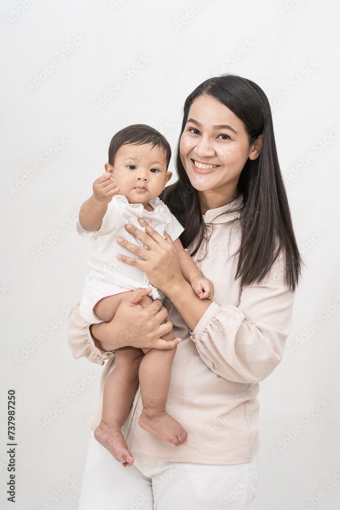 Beautiful mom holding baby girl and laughing very happy on isolated background. Beautiful mom holding baby girl and laughing very happy on isolated background.