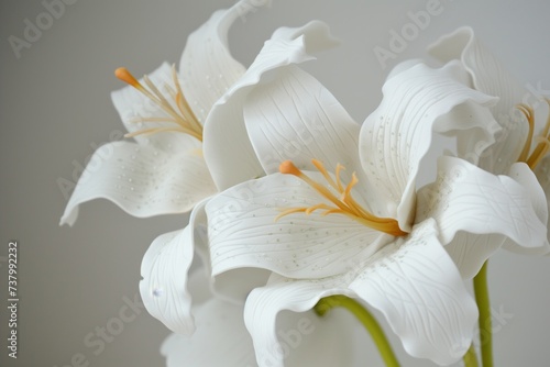 white fondant lilies with added texture and color details photo