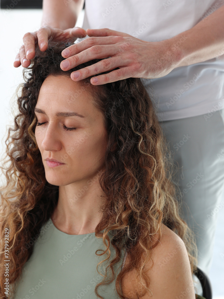 Naklejka premium Woman enjoying Energy Healing Reiki Treatment . Chakra Balancing, Aura cleansing, Holistic health care concept