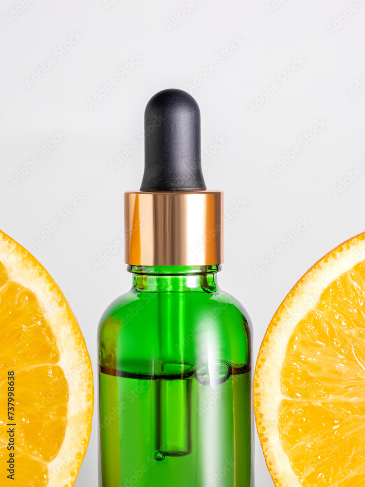 Cosmetic organic, vitamin C extract. Slices of orange and serum dropper bottle on white background. skin care concept