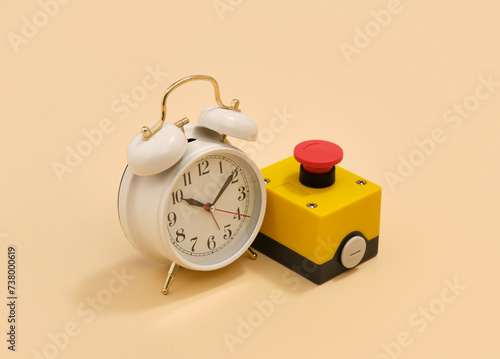 Retro white alarm clock and red start button. Time and work.