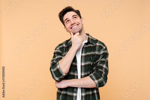 Pensive happy man holding hand near face, looking for creative solution isolated