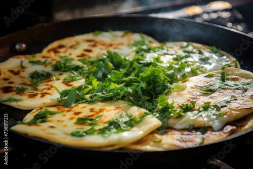 Frying flatbread filled with fresh herbs and cheese. Khychiny or qutab.