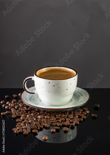 black coffee in a cup on a black background