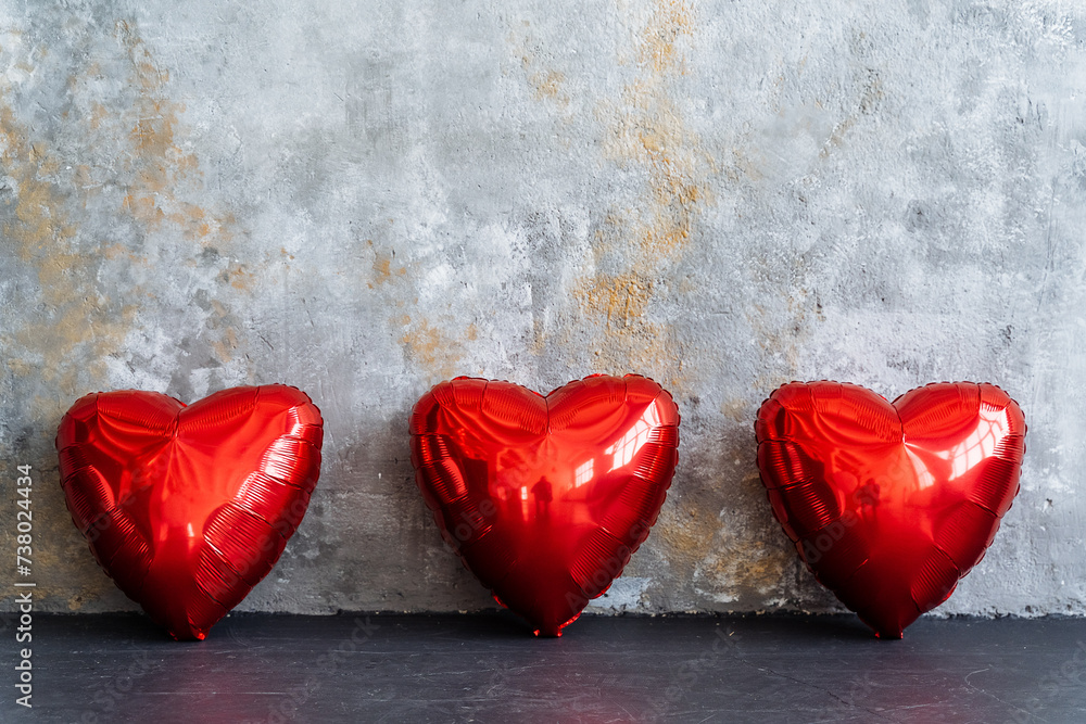 Three sweet red hearts are grouped together on the table Three sweet red hearts are grouped together on the table