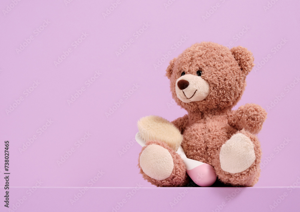 A teddy bear with a brush. Copy space for text. A teddy bear with a brush. Copy space for text.