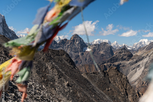Mounts Cholatse, Phari Lapche, Dragnag Ri and Buddhist prayer flags from Kongma La Pass during Everest Base Camp EBC or Three Passes trekking in Khumjung, Nepal. Highest mountains in the world. photo