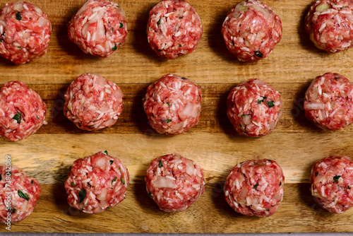 Raw beef meatballs on a cutting board .style hugge.top veiw