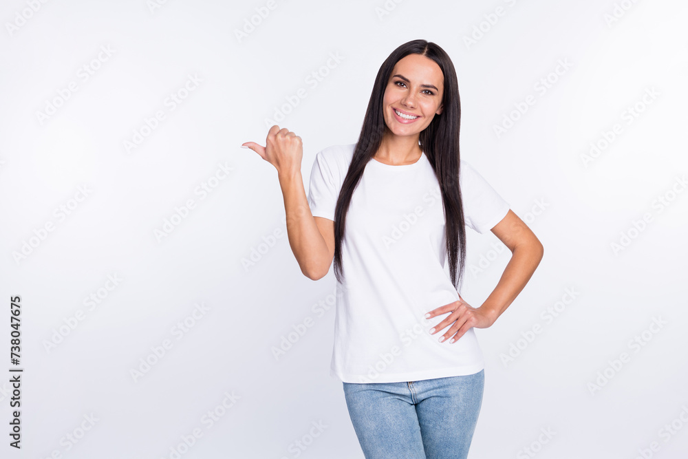 Photo portrait of smiling woman showing thumb empty space isolated on white color background Photo portrait of smiling woman showing thumb empty space isolated on white color background