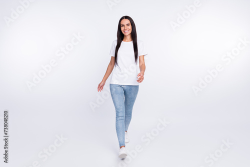 Full length body size photo of walking forward girl wearing casual outfit isolated on white color background