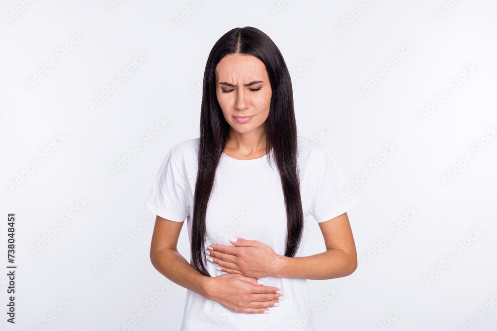 Photo portrait of woman feeling herself bad got stomach ache isolated on white color background Photo portrait of woman feeling herself bad got stomach ache isolated on white color background
