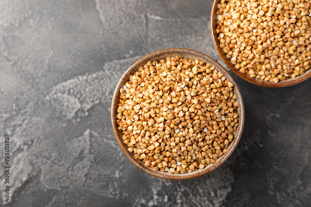 Green buckwheat in a bowl on a wooden kitchen table.Superfood.Raw buckwheat porridge.Healthy vegan food concept, eco products, diet. Copy space.Organic food.weight loss and proper nutrition. Green buckwheat in a bowl on a wooden kitchen table.Superfood.Raw buckwheat porridge.Healthy vegan food concept, eco products, diet. Copy space.Organic food.weight loss and proper nutrition.