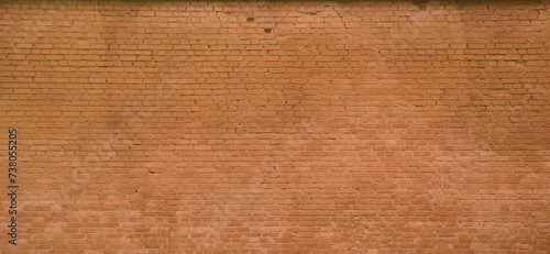 The texture of the brick wall of many rows of bricks painted in brown color photo