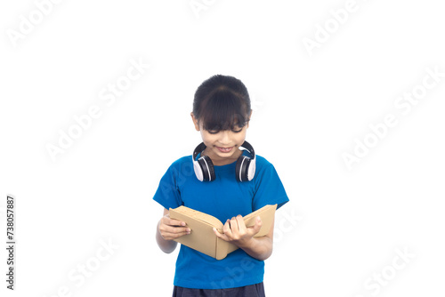 Young Asian girl reading a book and listening to music with headphones isolated on white background with clipping path.