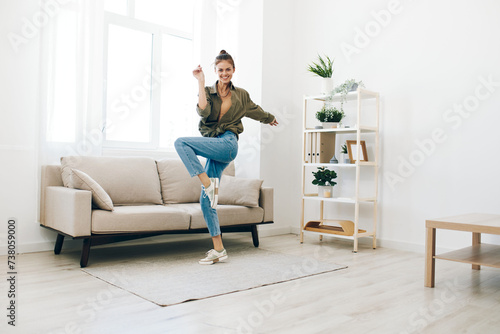 Joyful Woman Dancing and Singing in a Carefree, Playful Concept of Home Lifestyle © SHOTPRIME STUDIO