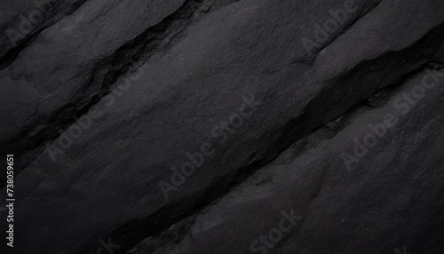A close-up of dark, rugged rock textures, highlighting the intricate patterns and deep shadows, Ideal for backgrounds, nature themes, or abstract art.