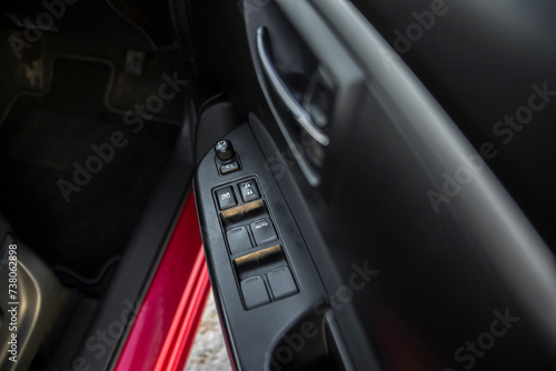 Car interior on the doors inside car door handle with power window control unit © OB production