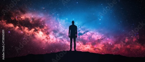 a man standing on top of a hill in front of a sky filled with stars and a star filled sky. © Jevjenijs