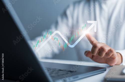 Businessman use computer laptop to analyze company profit growth, future business income increase graph, development to reach goals, business strategy, and financial data for long term investment.