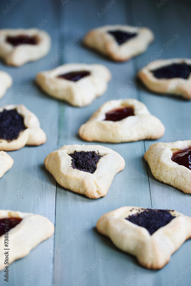 Variety of traditional hamantaschen cookies filled with mohn paste (poppy seed paste) and plum jam for the Jewish festival of Purim.