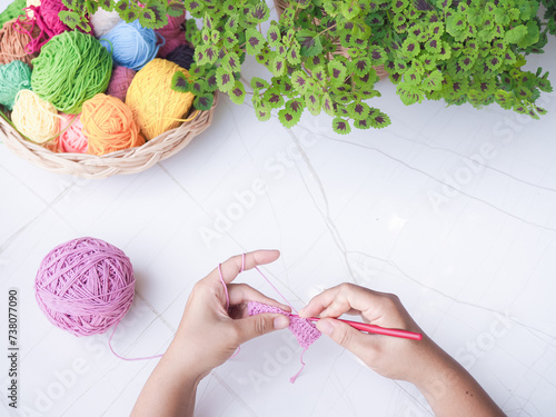 Close-up of woman hand knitting with pink wool