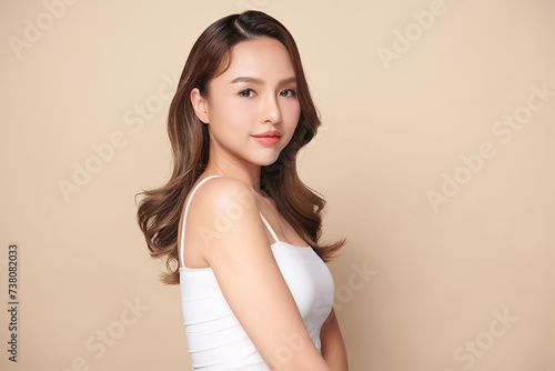 Beautiful young asian woman with clean fresh skin on beige background, Face care, Facial treatment, Cosmetology, beauty and spa, Asian women portrait.