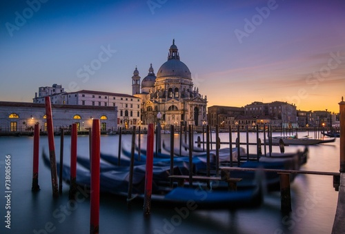 A Row of Gondolas Next to a Cathedral in Venice © onurcepheli