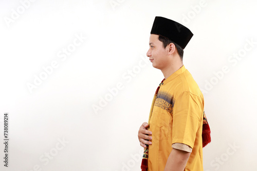 Young asian man wearing typical arab clothes isolated on white background gazing left, sideways pose. photo