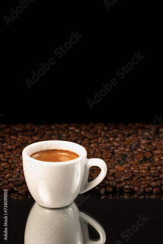 espresso coffee in white cup and coffee beans background