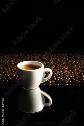 espresso coffee in white cup and coffee beans background