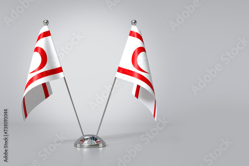 Double Turkish Republic of Northern Cyprus Table Flag on Gray Background. 3d Rendering photo