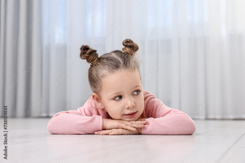 Cute little girl lying on warm floor at home. Heating system Cute little girl lying on warm floor at home. Heating system