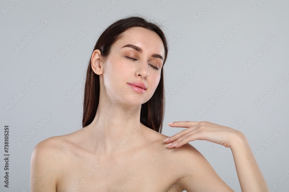 Portrait of beautiful young woman on light grey background Portrait of beautiful young woman on light grey background