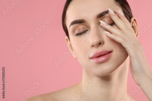 Beautiful young woman with healthy skin on pink background, closeup. Space for text