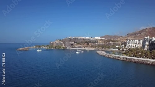 Summer flight near the sunny beach in Puerto Rico de Gran Canaria, Canary islands, Spain photo